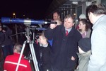 Professor Bailey showing the comet through a telescope