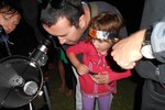 Parents and children view the night sky